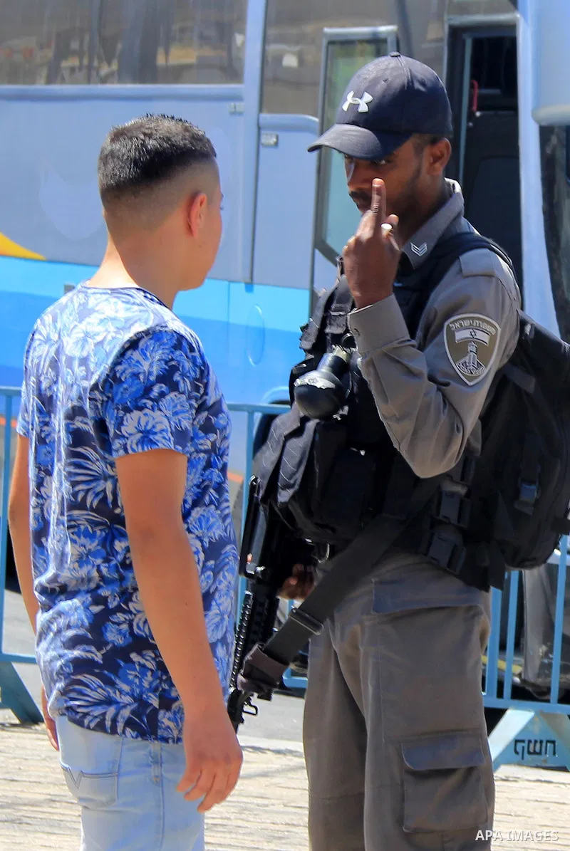 Israeli policeman argues with Palestinian youth following Friday prayer at al-Aqsa mosque on June 17, 2016 during the holy fasting month of Ramadan. Around 53,000 Palestinians from the West Bank were allowed into Jerusal...