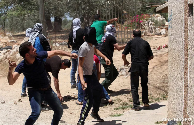Palestinian protesters hurl stones Israeli security forces during clashes following a demonstration against the expropriation of Palestinian land by Israel, on June 17, 2016 in the village of Kfar Qaddum, near Nablus, in...