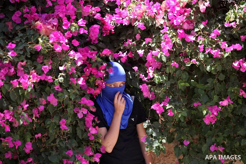 A Palestinian protester looks on during clashes with Israeli security forces following a demonstration against the expropriation of Palestinian land by Israel, on June 17, 2016 in the village of Kfar Qaddum, near Nablus,...