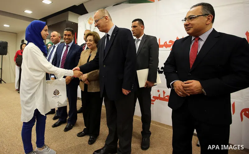 Palestinian Prime Minister, Rami Hamdallah, Participate in the central collective breakfast for the families of martyrs during the fasting month of Ramadan, in the West bank city of Ramallah, on June 17, 2016. Ramadan is...