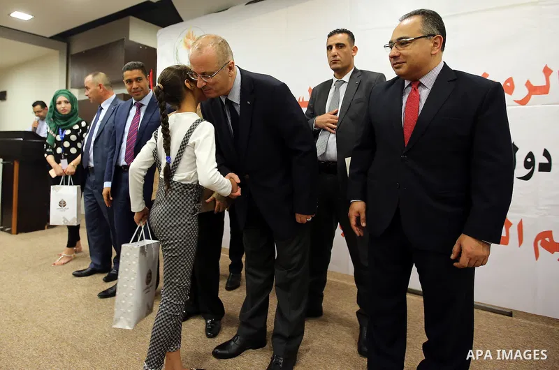 Palestinian Prime Minister, Rami Hamdallah, Participate in the central collective breakfast for the families of martyrs during the fasting month of Ramadan, in the West bank city of Ramallah, on June 17, 2016. Ramadan is...