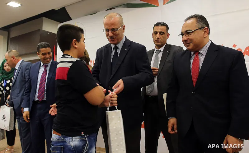 Palestinian Prime Minister, Rami Hamdallah, Participate in the central collective breakfast for the families of martyrs during the fasting month of Ramadan, in the West bank city of Ramallah, on June 17, 2016. Ramadan is...