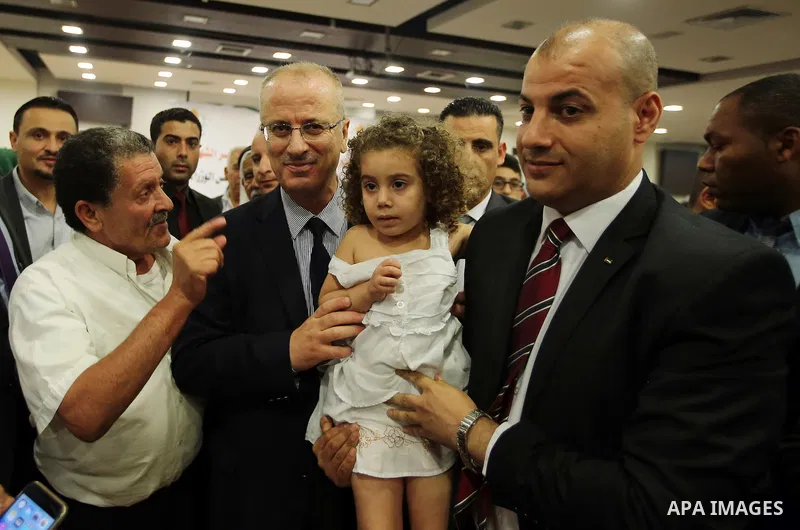 Palestinian Prime Minister, Rami Hamdallah, Participate in the central collective breakfast for the families of martyrs during the fasting month of Ramadan, in the West bank city of Ramallah, on June 17, 2016. Ramadan is...