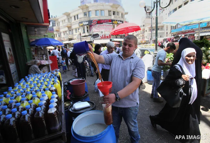 A Palestinian vendor prepares juices on the holy month of Ramadan at a market in the West bank city of Nablus, on June 18, 2016. Ramadan is sacred to Muslims because it is during that month that tradition says the Koran...
