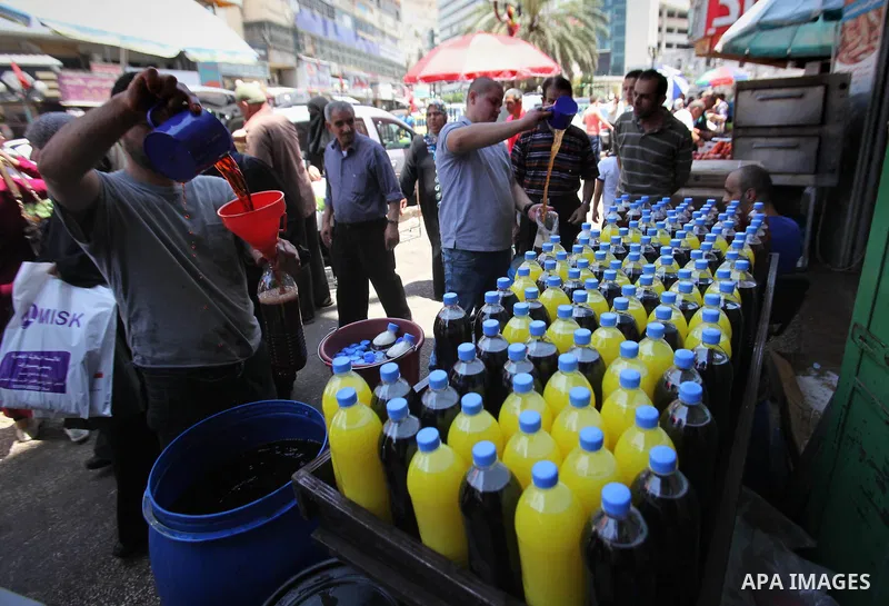 A Palestinian vendor prepares juices on the holy month of Ramadan at a market in the West bank city of Nablus, on June 18, 2016. Ramadan is sacred to Muslims because it is during that month that tradition says the Koran...