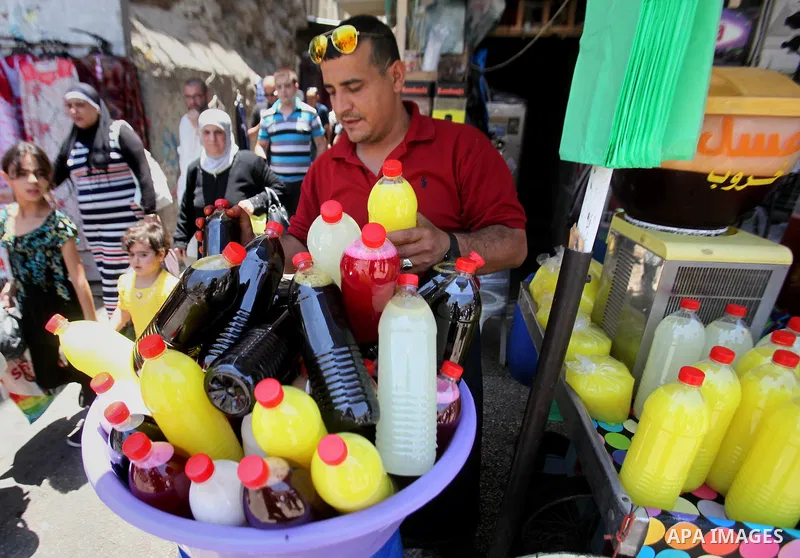 A Palestinian vendor prepares juices on the holy month of Ramadan at a market in the West bank city of Nablus, on June 18, 2016. Ramadan is sacred to Muslims because it is during that month that tradition says the Koran...