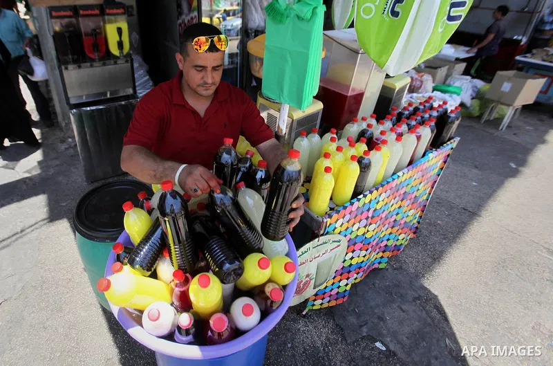 A Palestinian vendor prepares juices on the holy month of Ramadan at a market in the West bank city of Nablus, on June 18, 2016. Ramadan is sacred to Muslims because it is during that month that tradition says the Koran...