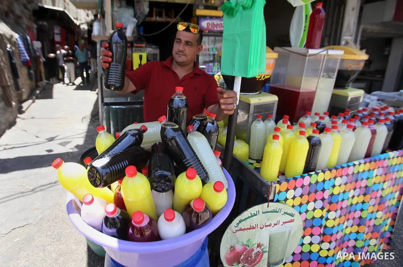 A Palestinian vendor prepares juices on the holy month of Ramadan at a market in the West bank city of Nablus, on June 18, 2016. Ramadan is sacred to Muslims because it is during that month that tradition says the Koran...