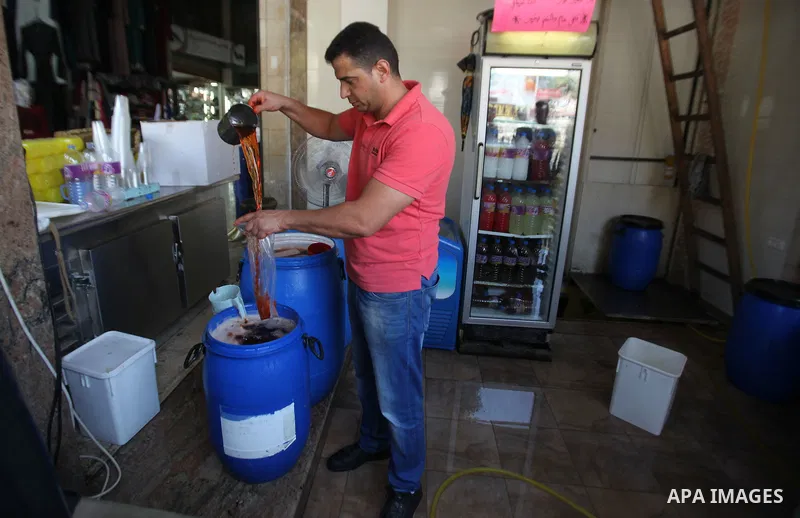 A Palestinian vendor prepares juices on the holy month of Ramadan at a market in the West bank city of Nablus, on June 18, 2016. Ramadan is sacred to Muslims because it is during that month that tradition says the Koran...