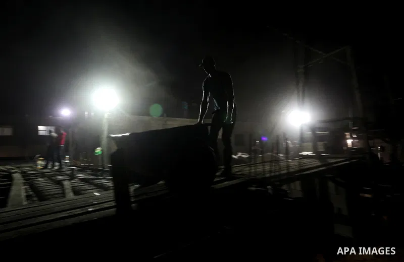 Palestinian construction workers work in Shajaiyeh neighborhood in Gaza city, on June 18, 2016. Palestinian construction workers work during the night in the month of Ramadan because of the high temperatures they can not...