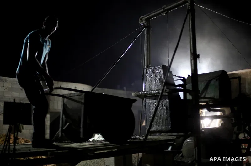 Palestinian construction workers work in Shajaiyeh neighborhood in Gaza city, on June 18, 2016. Palestinian construction workers work during the night in the month of Ramadan because of the high temperatures they can not...