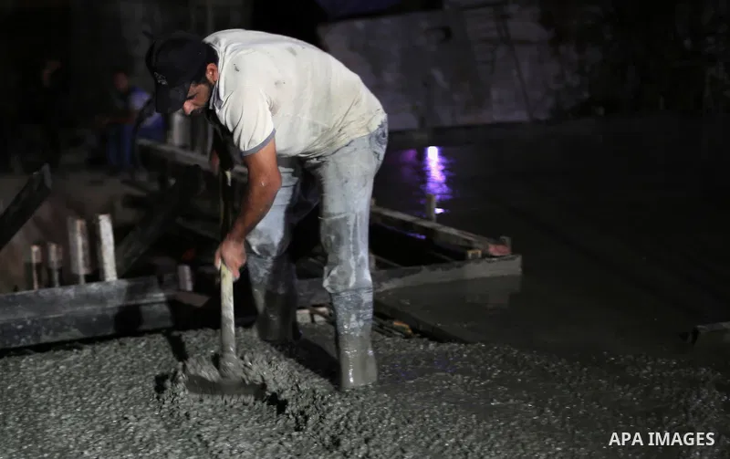 Palestinian construction workers work in Shajaiyeh neighborhood in Gaza city, on June 18, 2016. Palestinian construction workers work during the night in the month of Ramadan because of the high temperatures they can not...