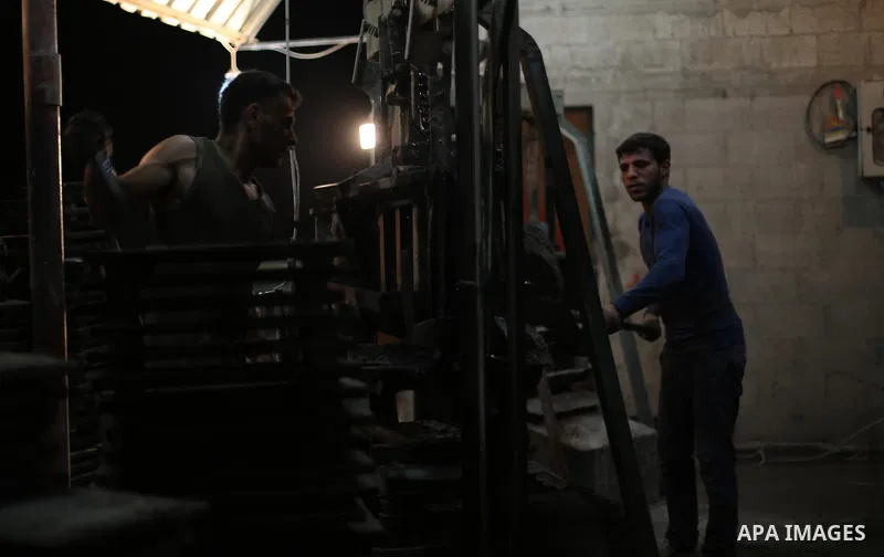 Palestinian construction workers work in Shajaiyeh neighborhood in Gaza city, on June 18, 2016. Palestinian construction workers work during the night in the month of Ramadan because of the high temperatures they can not...