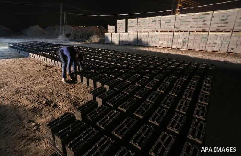 Palestinian construction workers work in Shajaiyeh neighborhood in Gaza city, on June 18, 2016. Palestinian construction workers work during the night in the month of Ramadan because of the high temperatures they can not...