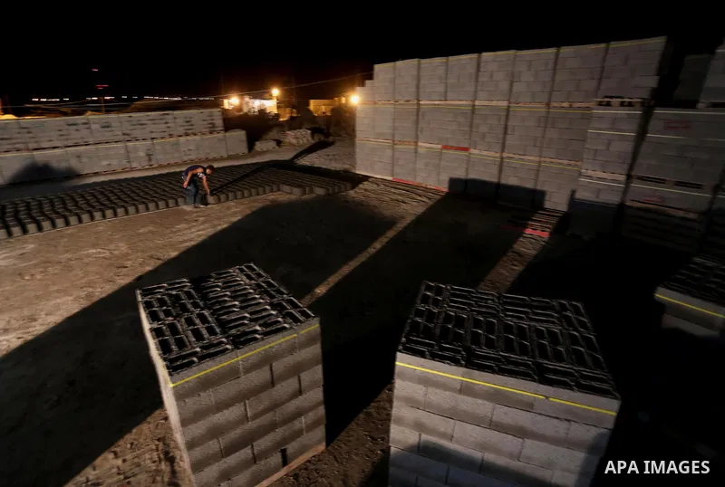Palestinian construction workers work in Shajaiyeh neighborhood in Gaza city, on June 18, 2016. Palestinian construction workers work during the night in the month of Ramadan because of the high temperatures they can not...