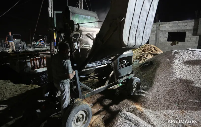 Palestinian construction workers work in Shajaiyeh neighborhood in Gaza city, on June 18, 2016. Palestinian construction workers work during the night in the month of Ramadan because of the high temperatures they can not...