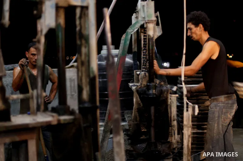 Palestinian construction workers work in Shajaiyeh neighborhood in Gaza city, on June 18, 2016. Palestinian construction workers work during the night in the month of Ramadan because of the high temperatures they can not...