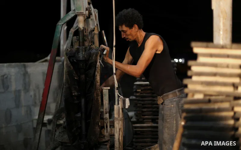 Palestinian construction workers work in Shajaiyeh neighborhood in Gaza city, on June 18, 2016. Palestinian construction workers work during the night in the month of Ramadan because of the high temperatures they can not...