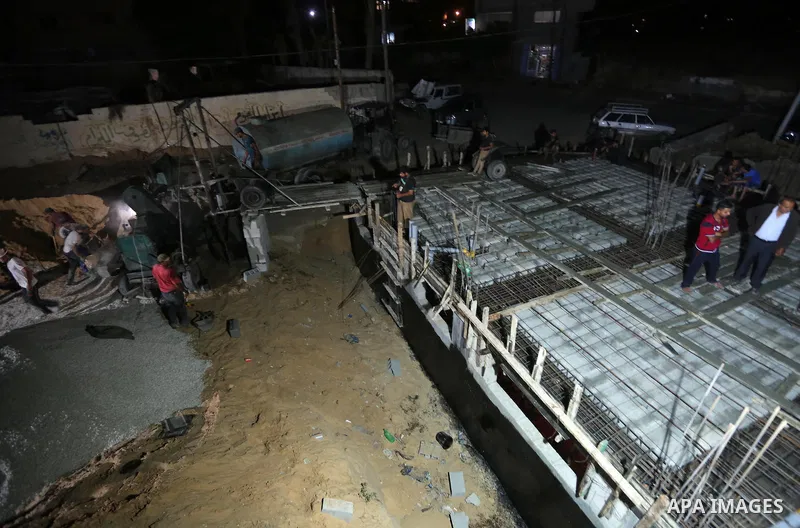 Palestinian construction workers work in Shajaiyeh neighborhood in Gaza city, on June 18, 2016. Palestinian construction workers work during the night in the month of Ramadan because of the high temperatures they can not...