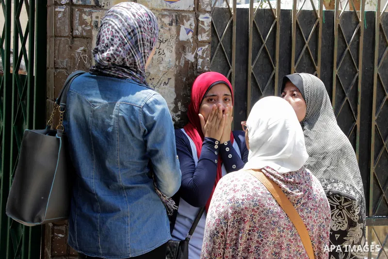 Egyptian students react outside their school following the final high school exams known as ''Tawjihi'', in Cairo on June 19, 2016. Photo by Amr Sayed