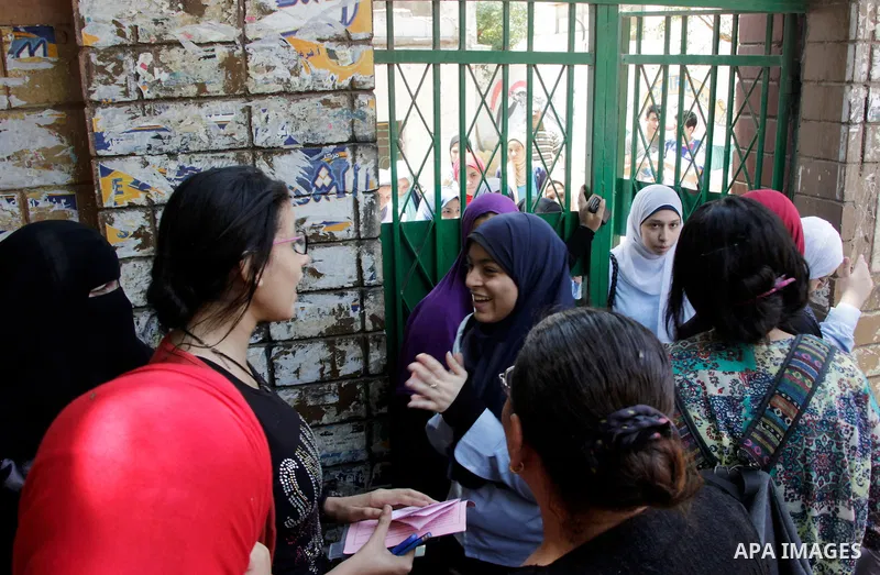 Egyptian students react outside their school following the final high school exams known as ''Tawjihi'', in Cairo on June 19, 2016. Photo by Amr Sayed