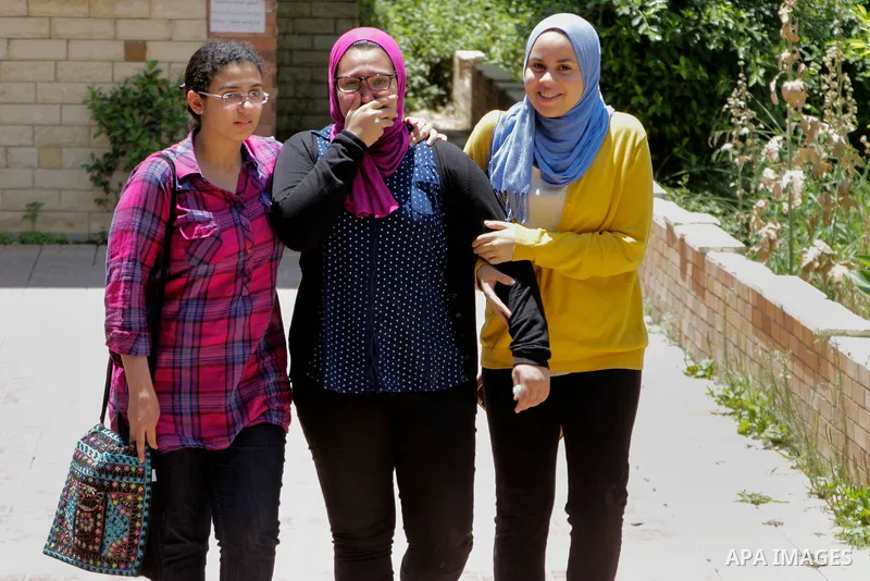 Egyptian students react outside their school following the final high school exams known as ''Tawjihi'', in Cairo on June 19, 2016. Photo by Amr Sayed