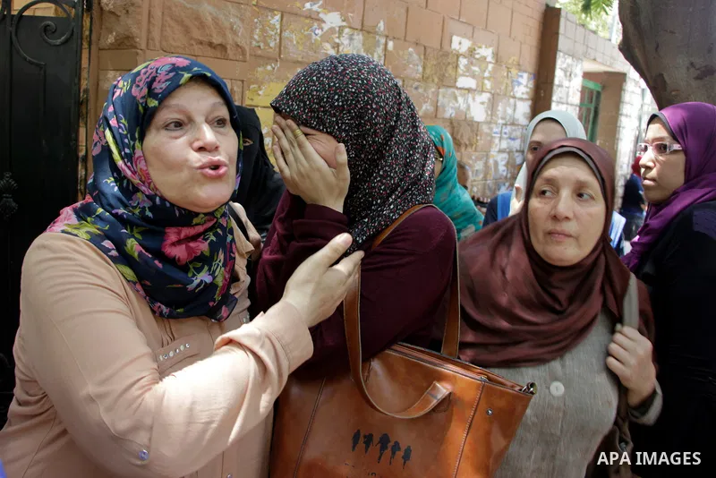 Egyptian students react outside their school following the final high school exams known as ''Tawjihi'', in Cairo on June 19, 2016. Photo by Amr Sayed