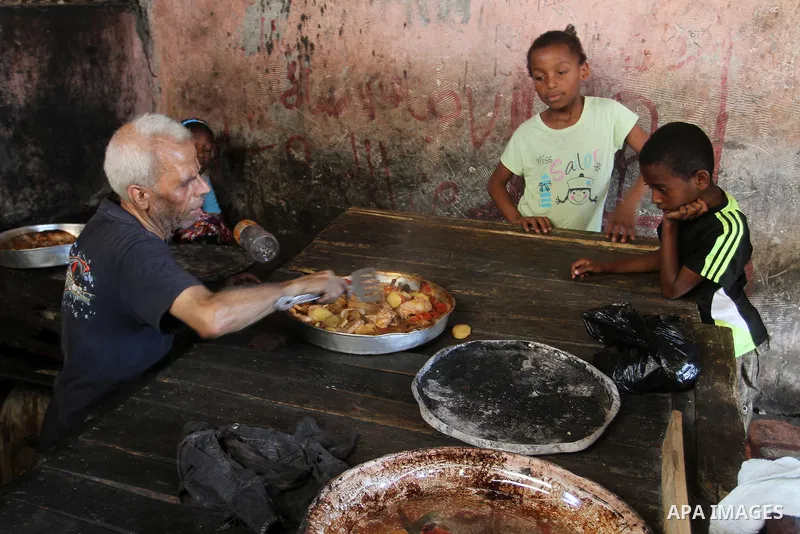 A Palestinian man cooks foods in a traditional mud oven during the holy fasting month of Ramadan, in Rafah in the southern Gaza Strip on June 19, 2016. Ramadan is sacred to Muslims because it is during that month that tr...
