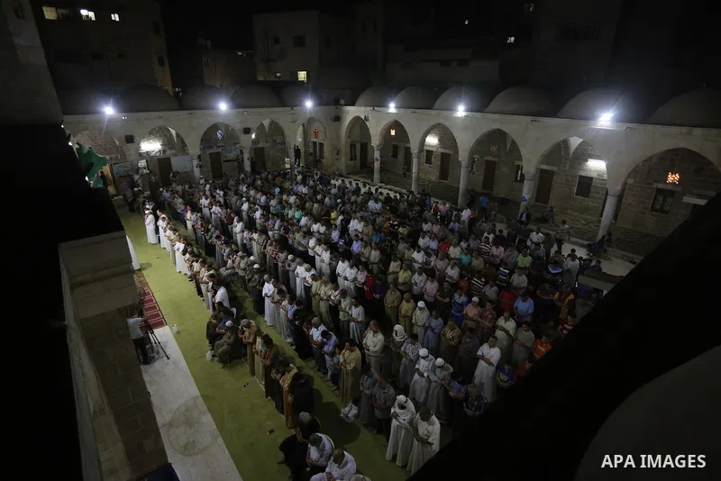 Palestinian Muslim worshipers perform "Taraweeh", nightly prayer of the month of Ramadan in Gaza city on June 19, 2016. Ramadan is sacred to Muslims because it is during that month that tradition says the Koran was revea...