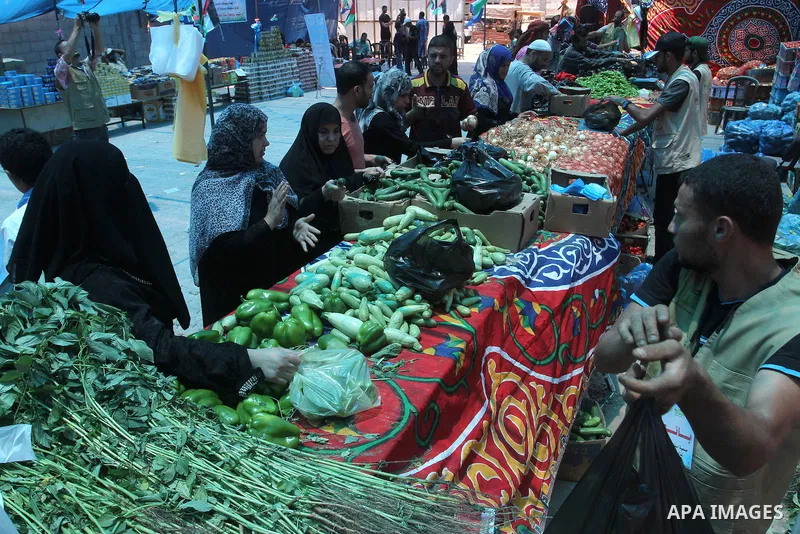 Palestinians shop at the Ramadan Charity market for poor families, Funded by "Gift of the Givers" South Africa, in Khan Younis in the southern Gaza strip, on June 20, 2016. Photo by Abed Rahim Khatib