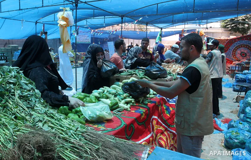 Palestinians shop at the Ramadan Charity market for poor families, Funded by "Gift of the Givers" South Africa, in Khan Younis in the southern Gaza strip, on June 20, 2016. Photo by Abed Rahim Khatib