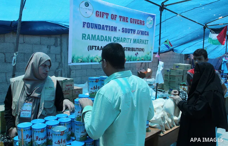 Palestinians shop at the Ramadan Charity market for poor families, Funded by "Gift of the Givers" South Africa, in Khan Younis in the southern Gaza strip, on June 20, 2016. Photo by Abed Rahim Khatib