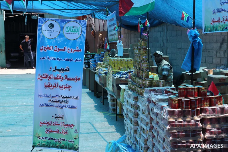 Palestinians shop at the Ramadan Charity market for poor families, Funded by "Gift of the Givers" South Africa, in Khan Younis in the southern Gaza strip, on June 20, 2016. Photo by Abed Rahim Khatib