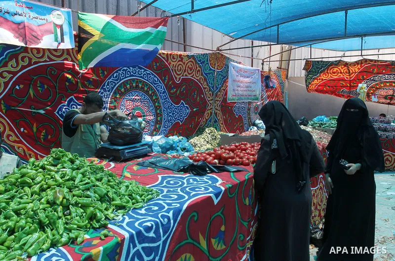 Palestinians shop at the Ramadan Charity market for poor families, Funded by "Gift of the Givers" South Africa, in Khan Younis in the southern Gaza strip, on June 20, 2016. Photo by Abed Rahim Khatib