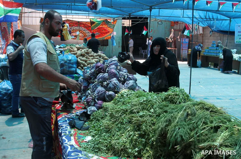 Palestinians shop at the Ramadan Charity market for poor families, Funded by "Gift of the Givers" South Africa, in Khan Younis in the southern Gaza strip, on June 20, 2016. Photo by Abed Rahim Khatib