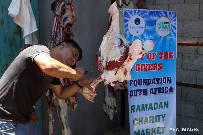 Palestinians shop at the Ramadan Charity market for poor families, Funded by "Gift of the Givers" South Africa, in Khan Younis in the southern Gaza strip, on June 20, 2016. Photo by Abed Rahim Khatib