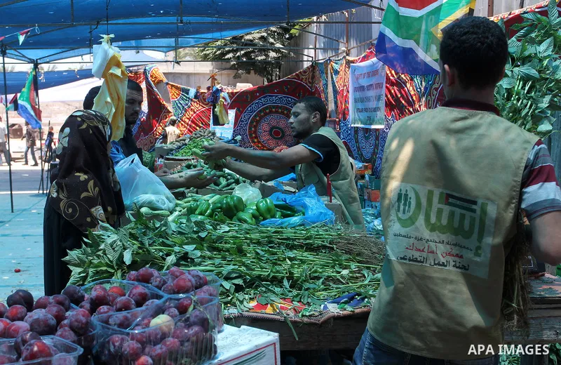 Palestinians shop at the Ramadan Charity market for poor families, Funded by "Gift of the Givers" South Africa, in Khan Younis in the southern Gaza strip, on June 20, 2016. Photo by Abed Rahim Khatib