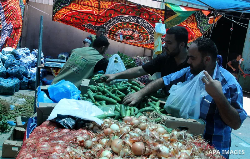 Palestinians shop at the Ramadan Charity market for poor families, Funded by "Gift of the Givers" South Africa, in Khan Younis in the southern Gaza strip, on June 20, 2016. Photo by Abed Rahim Khatib