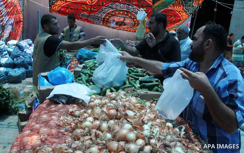 Palestinians shop at the Ramadan Charity market for poor families, Funded by "Gift of the Givers" South Africa, in Khan Younis in the southern Gaza strip, on June 20, 2016. Photo by Abed Rahim Khatib