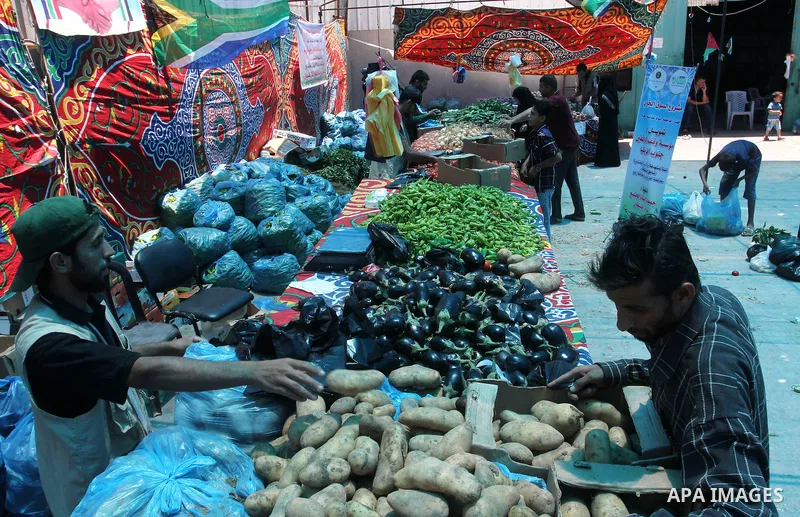 Palestinians shop at the Ramadan Charity market for poor families, Funded by "Gift of the Givers" South Africa, in Khan Younis in the southern Gaza strip, on June 20, 2016. Photo by Abed Rahim Khatib