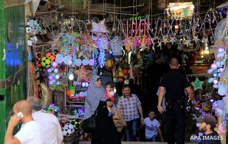Palestinians shop at a market during the holy fasting month of Ramadan, in Jerusalem's old city on June 20, 2016. Ramadan is sacred to Muslims because it is during that month that tradition says the Koran was revealed to...