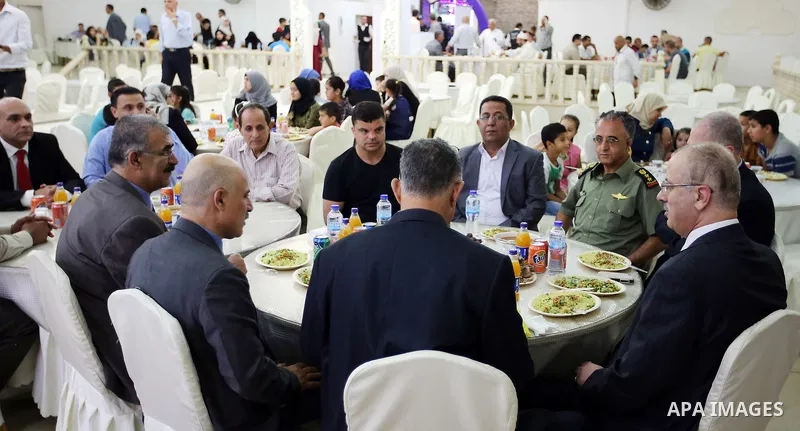 Palestinian Prime Minister Rami Hamdallah takes part during take breakfast on holy fasting month of Ramadan, in the West Bank city of Tulkarem, on June 20, 2016. Photo by Prime Minister Office