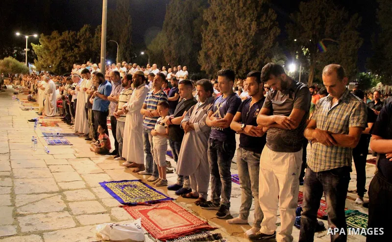 Palestinian Muslim worshippers perform "Taraweeh", nightly prayer of the month of Ramadan, in front of the Dome of the Rock mosque, in Jerusalem's old city on June 20, 2016. Ramadan is sacred to Muslims because it is dur...