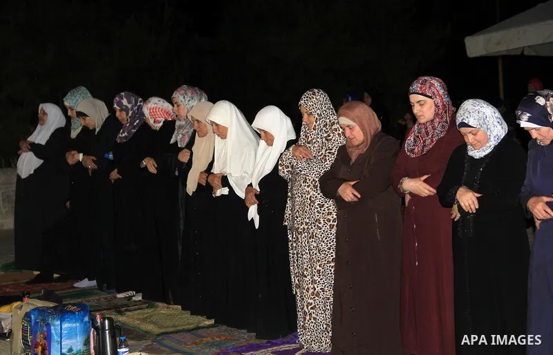 Palestinian Muslim worshippers perform "Taraweeh", nightly prayer of the month of Ramadan, in front of the Dome of the Rock mosque, in Jerusalem's old city on June 20, 2016. Ramadan is sacred to Muslims because it is dur...