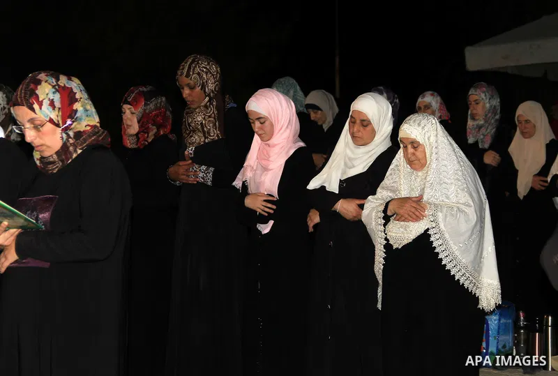 Palestinian Muslim worshippers perform "Taraweeh", nightly prayer of the month of Ramadan, in front of the Dome of the Rock mosque, in Jerusalem's old city on June 20, 2016. Ramadan is sacred to Muslims because it is dur...