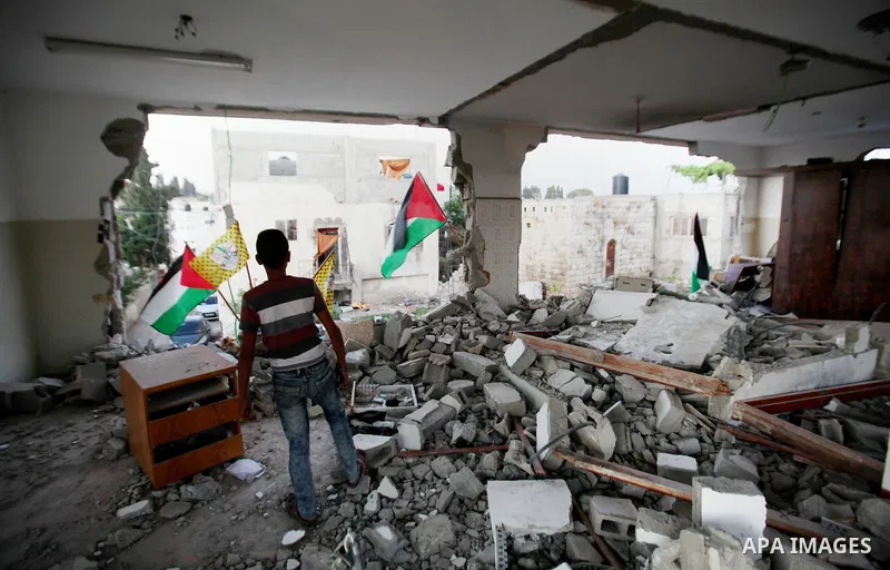A Palestinian boy inspects the home of the Bashar Masalha that was demolished by the Israeli military in the West bank city of Qalqilya, on June 21, 2016. Bashar Masalha was killed in Jaffa city on 8 March 2016, under th...