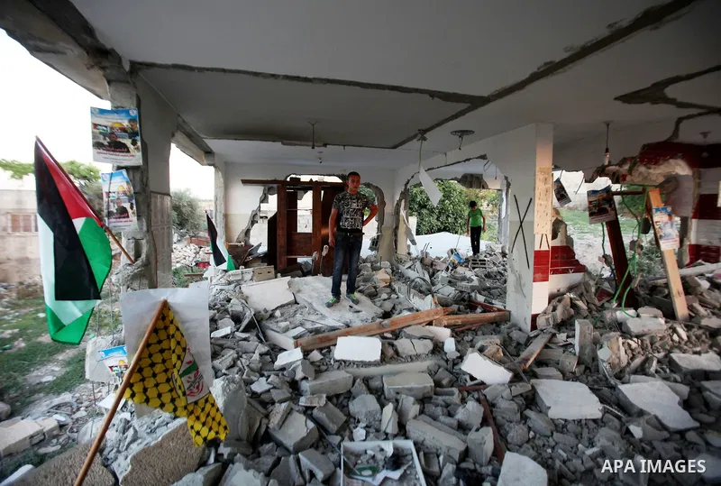 A Palestinian boy inspects the home of the Bashar Masalha that was demolished by the Israeli military in the West bank city of Qalqilya, on June 21, 2016. Bashar Masalha was killed in Jaffa city on 8 March 2016, under th...