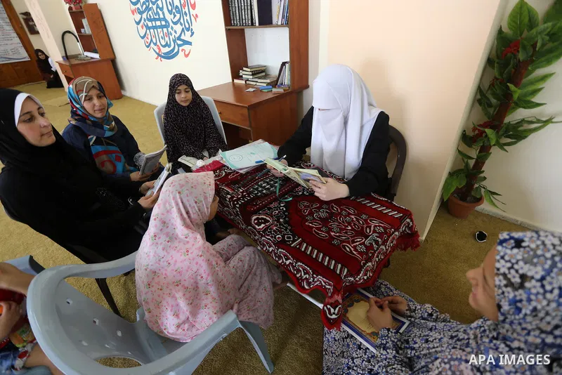 Palestinian girls read the Koran, Islam's holy book, at a religion school in Gaza City on June 21, 2016, during the Muslim fasting month of Ramadan. Photo by Mohammed Asad