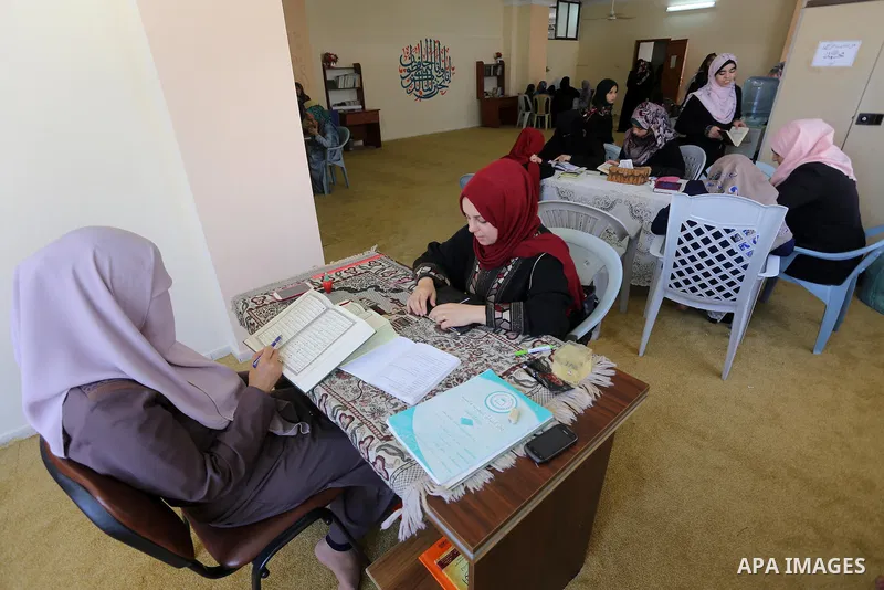 Palestinian girls read the Koran, Islam's holy book, at a religion school in Gaza City on June 21, 2016, during the Muslim fasting month of Ramadan. Photo by Mohammed Asad