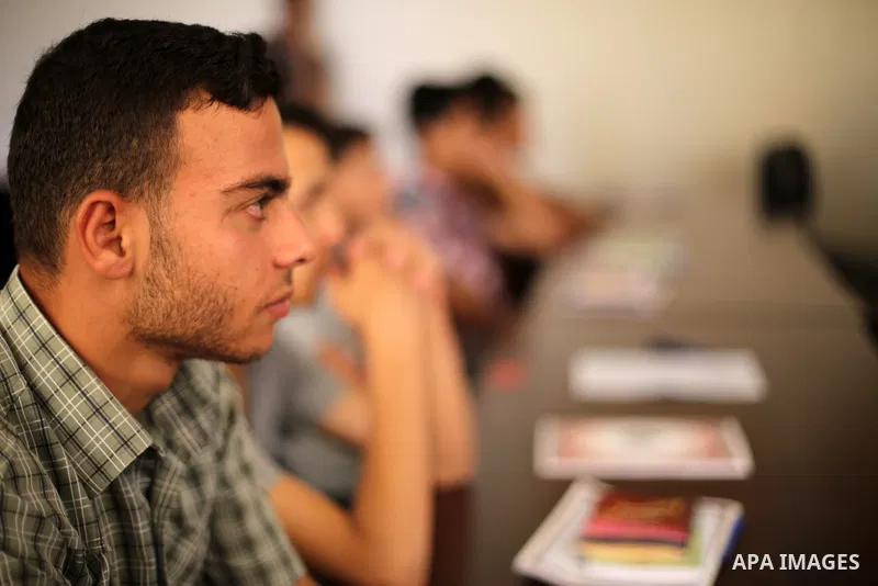 Palestinian deaf students react during A Palestinian imam uses sign-language to teach them the Koran, Islam's holy book at a religion school in Gaza City on June 21 2016, during the Muslim fasting month of Ramadan. Photo...